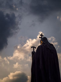 Low angle view of buddha statue against sky