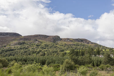 Scenic view of mountains against cloudy sky