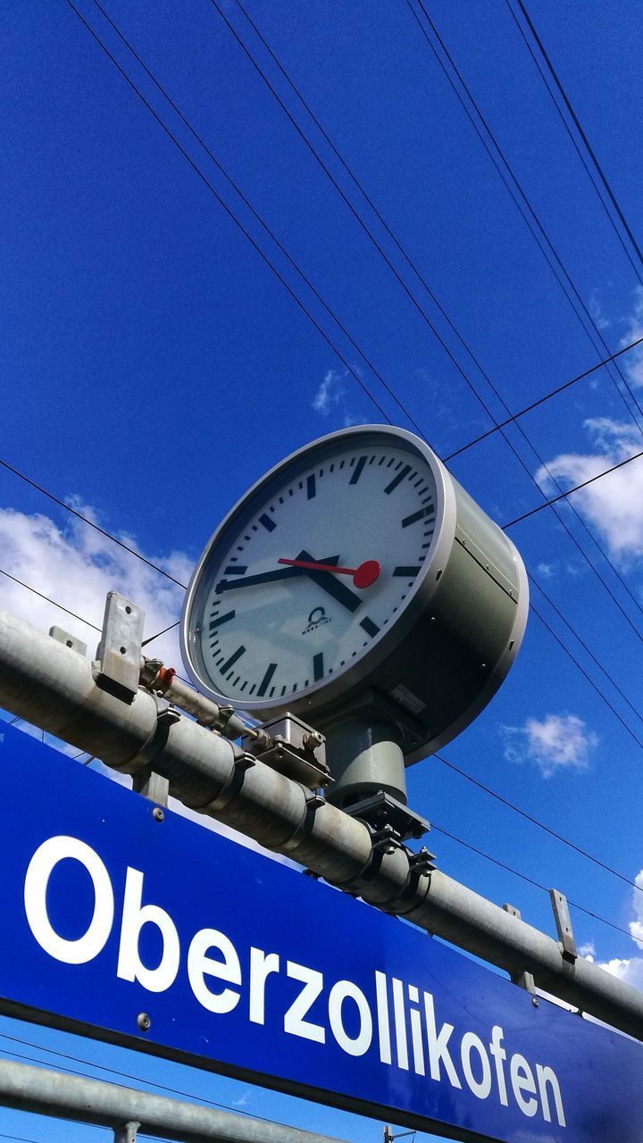 LOW ANGLE VIEW OF CLOCK AT RAILROAD STATION AGAINST SKY