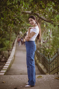 Portrait of smiling young woman standing outdoors