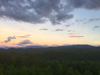 Scenic view of silhouette mountains against sky at sunset