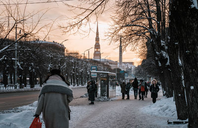 Rear view of people walking on street
