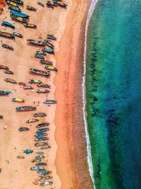 Aerial view of boats moored at beach by sea