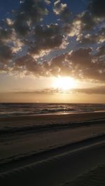 Scenic view of beach against sky during sunset