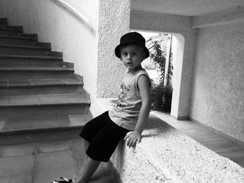 Portrait of young woman standing on tiled floor