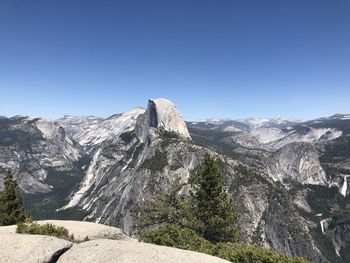 Scenic view of mountains against clear blue sky