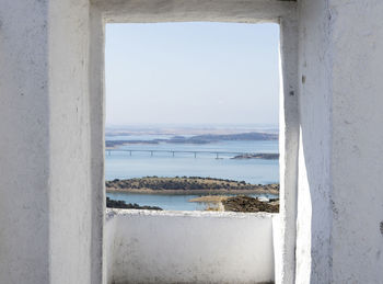 Scenic view of sea against sky seen through window