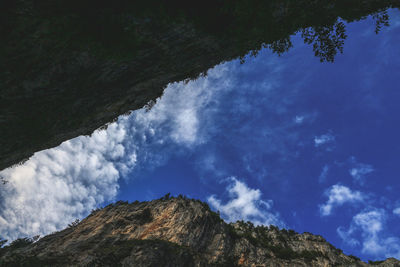 Low angle view of mountain against blue sky