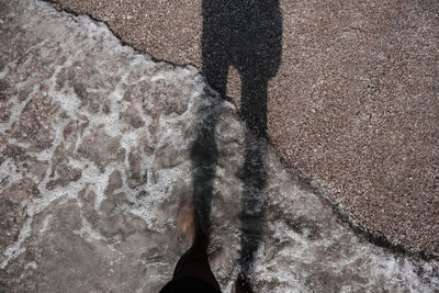 Low section of person standing on rock