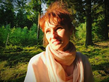 Portrait of smiling young woman in forest