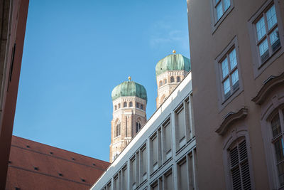 Low angle view of buildings against blue sky