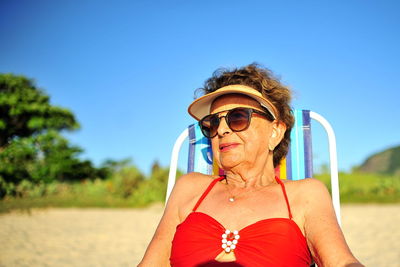 Portrait of woman against blue sky