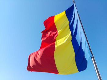Low angle view of romanian flag against clear sky