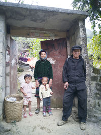 Full length portrait of friends standing in basket