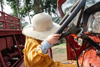 Cute childen yellow dress on red car