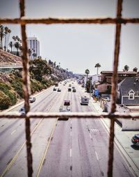 Road by city against sky