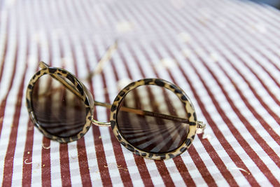 Close-up of sunglass on tablecloth