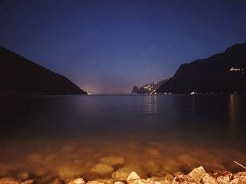 Scenic view of sea against clear sky at night