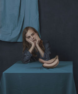 Portrait of young woman sitting on stage