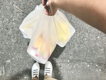 Low section of woman standing on street