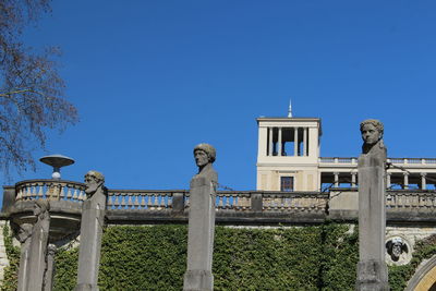 Low angle view of statue against clear blue sky