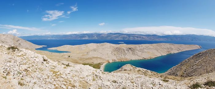 Panoramic view of landscape and mountains against blue sky