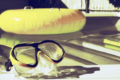 Swimming goggles at poolside during sunset