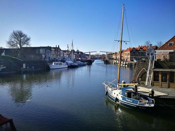 Boats moored on sea against clear sky