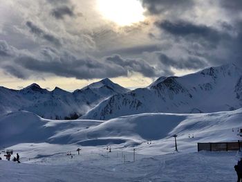 Scenic view of snow covered mountains against sky