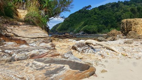 Scenic view of river by mountains against sky