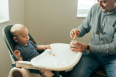 Portrait of boy playing with toy at home