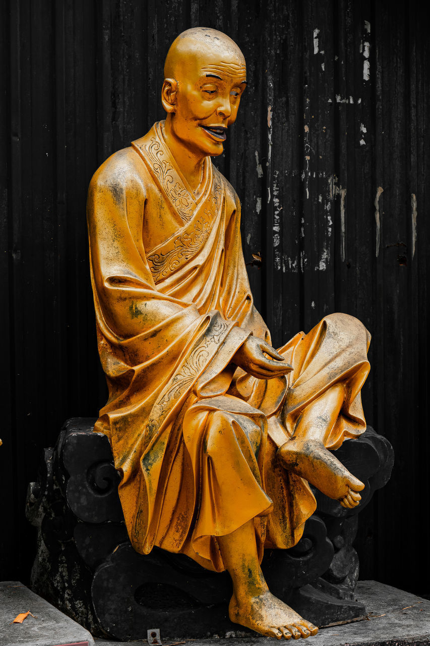 STATUE OF BUDDHA AGAINST TEMPLE