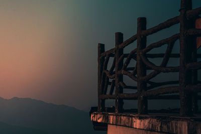Metallic structure against sky during sunset
