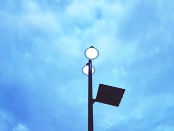 Low angle view of street light against blue sky