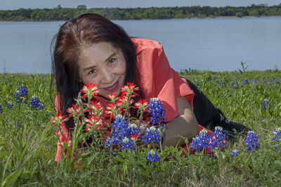 Portrait of woman with pink flowers in park