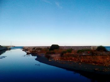 View of calm sea against clear blue sky