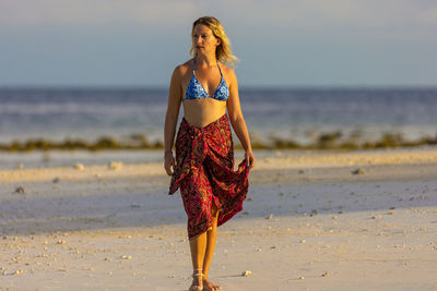 Young woman standing at beach