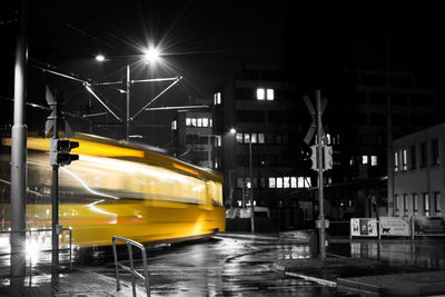 Yellow car on illuminated street at night