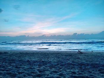 Scenic view of sea against cloudy sky