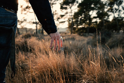Low section of man standing on field