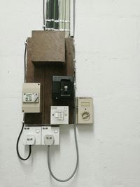 Close-up of telephone booth against wall