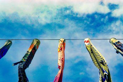 Low angle view of flags against sky