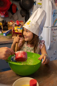 Close-up of girl mixing ingredients in a mixing bowl