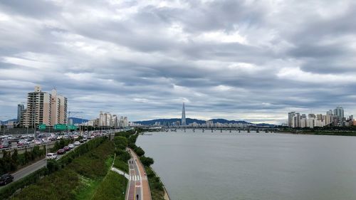 View of buildings in city against cloudy sky