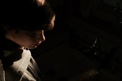 High angle view of woman standing by kitchen sink on sunny day
