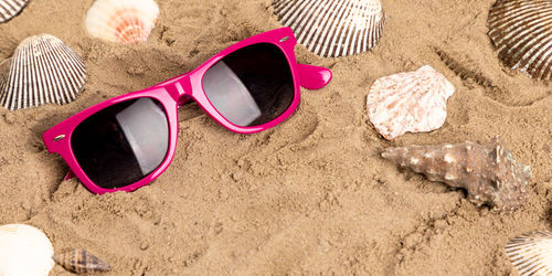 High angle view of sunglasses on beach
