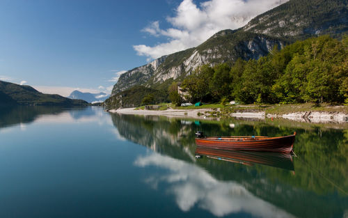 Scenic view of calm lake with mountains in background