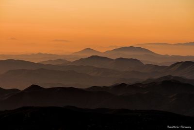 Scenic view of silhouette mountains against sky during sunset