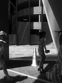 Full length of woman standing by railing