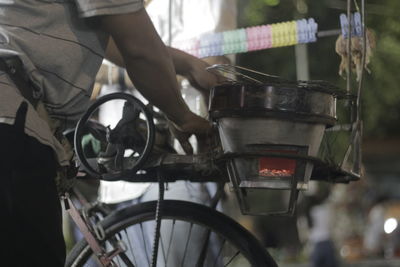 Close-up of man holding bicycle